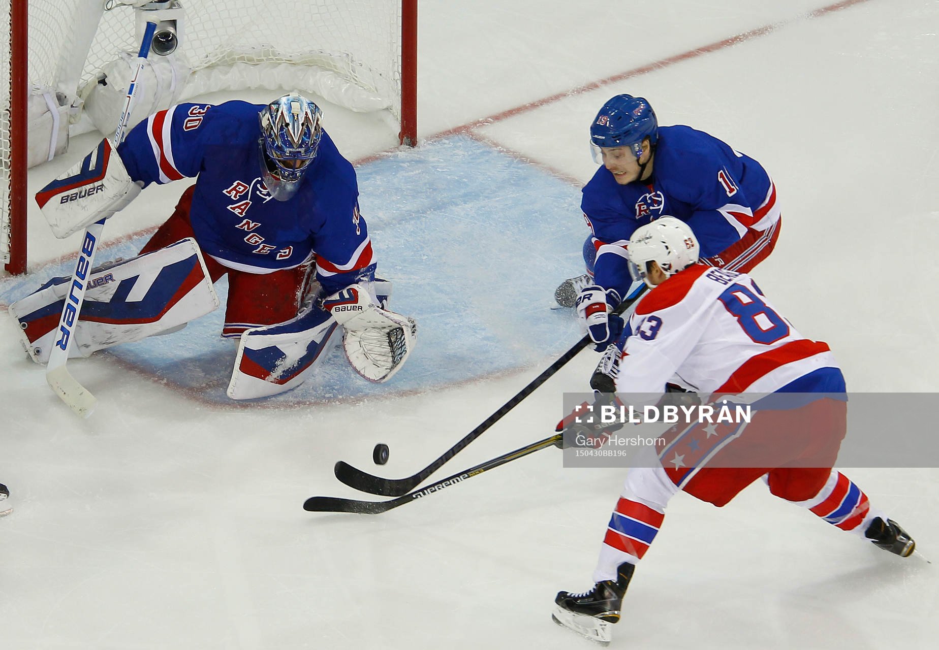 New York Rangers Jesper Fast (C) knocks the puck away from
