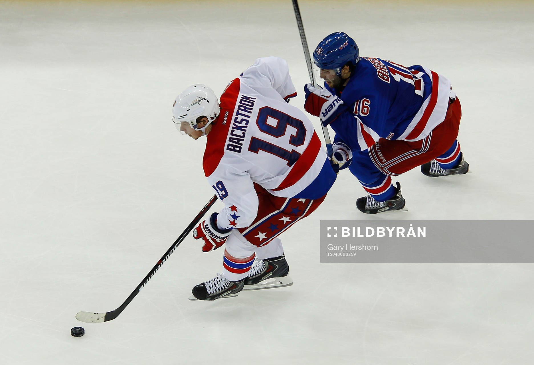 Washington Capitals Nicklas Bäckstrom (L) skates away from