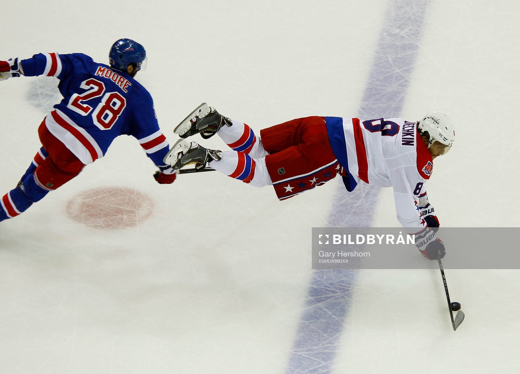 Washington Capitals Alex Ovechkin (R) is upended by New