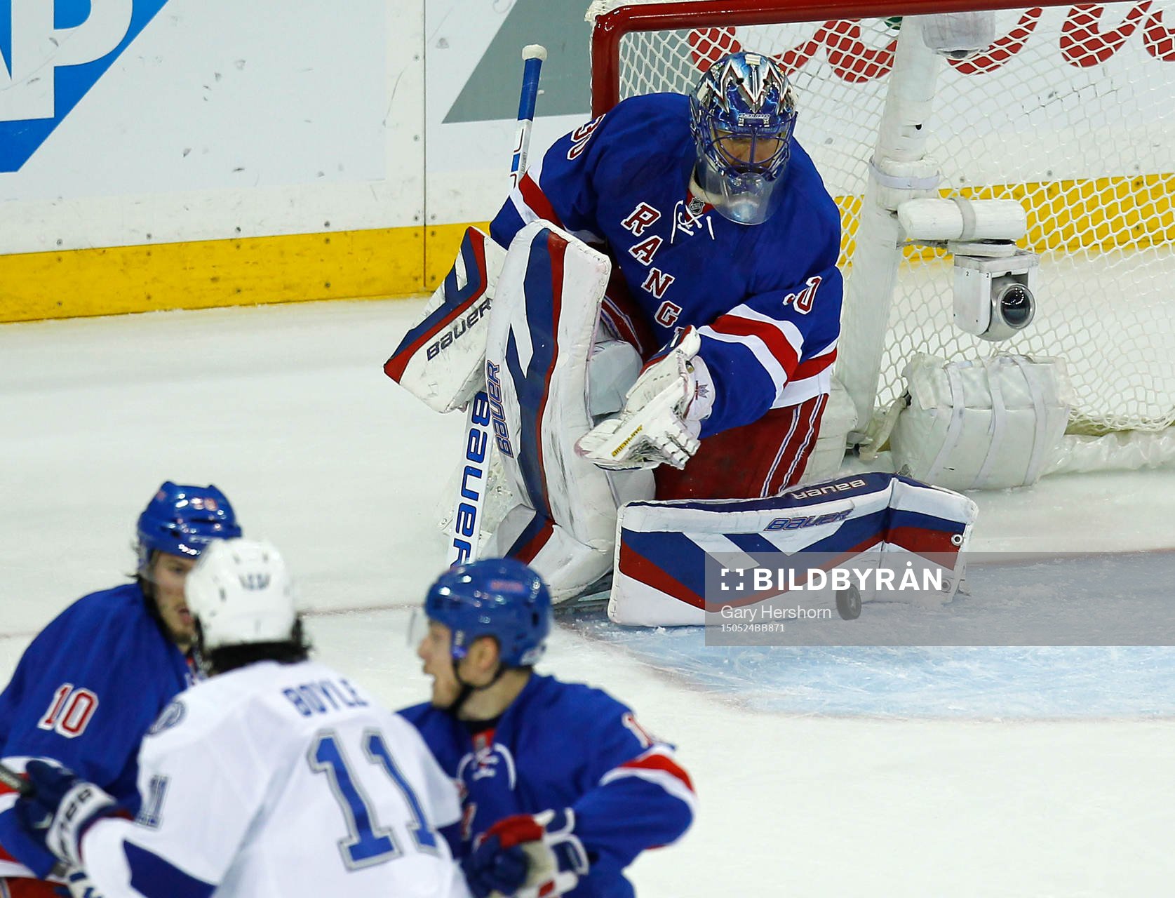 New York Rangers goalie Henrik Lundqvist (R) makes a save