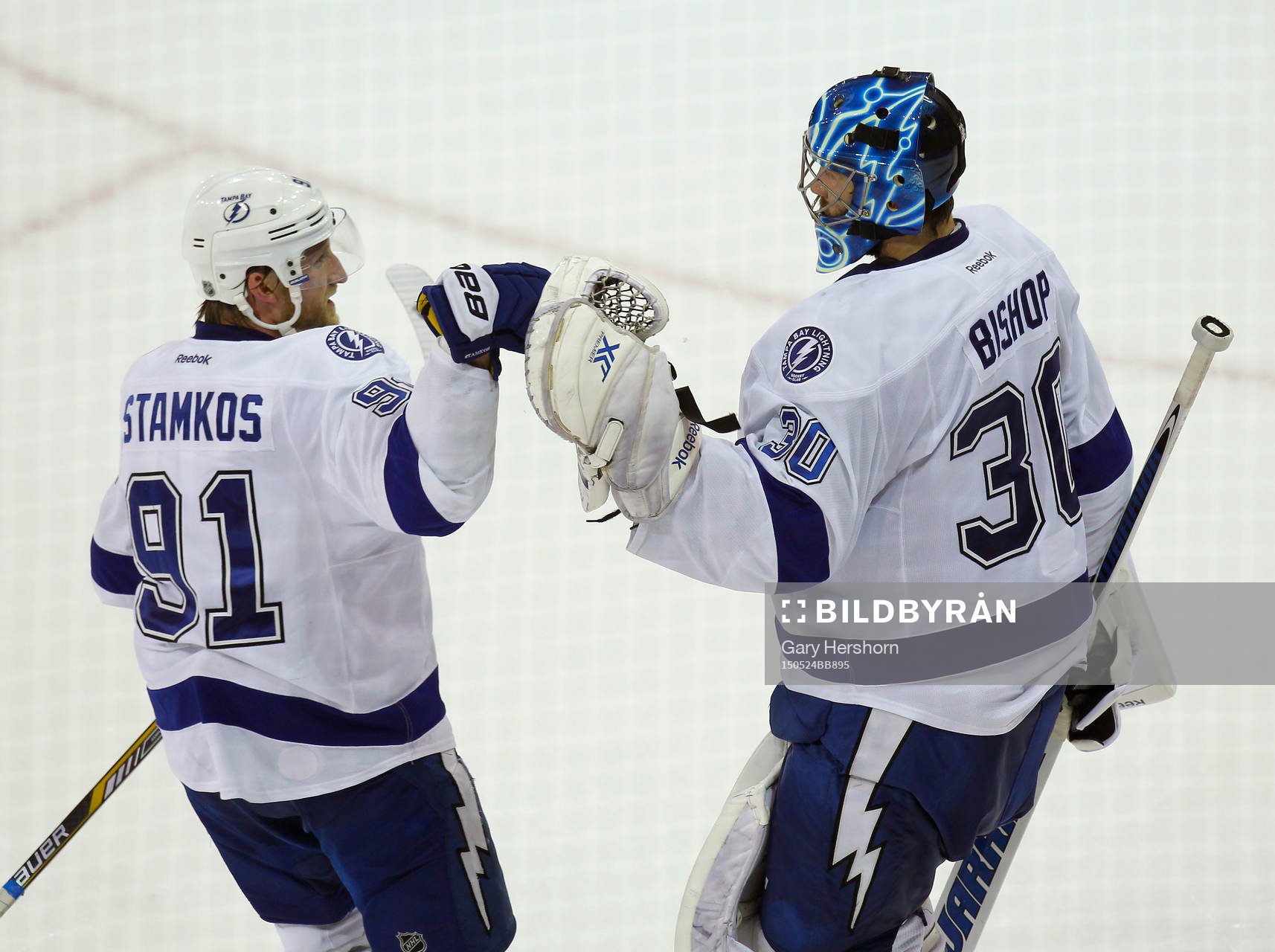 Tampa Bay Lightning goalie Ben Bishop (R) is congratulated