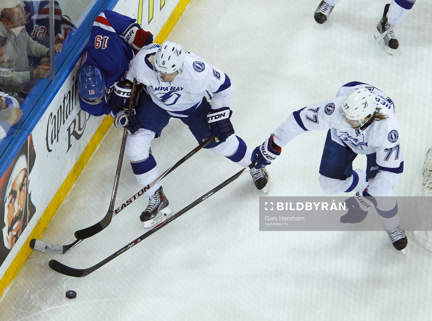 New York Rangers Jesper Fast (L) is checked into the boards