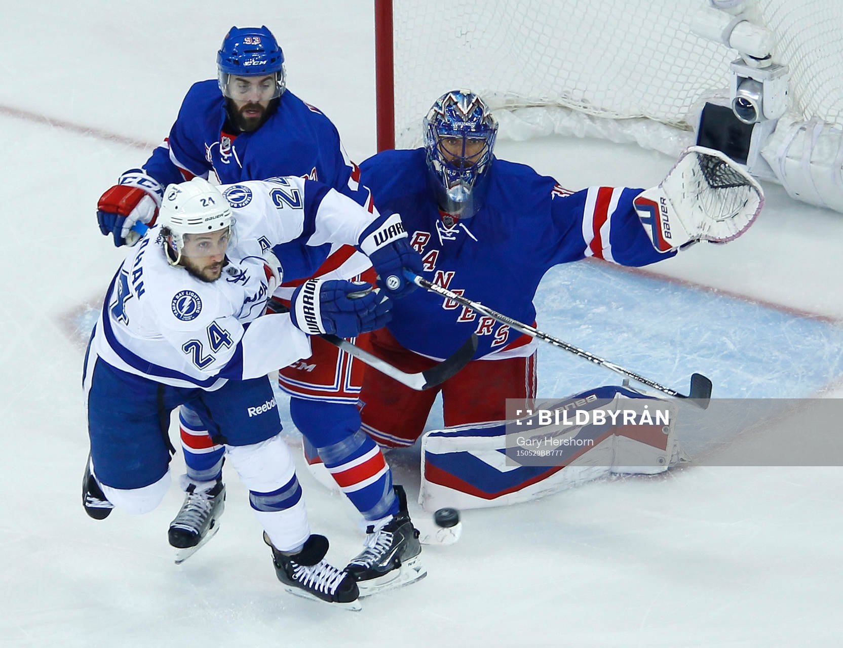 New York Rangers goalie Henrik Lundqvist (R) makes a save