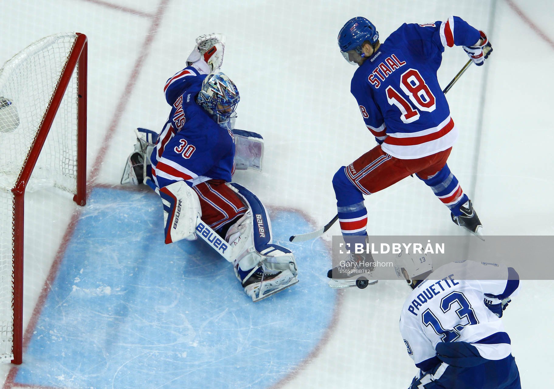 New York Rangers goalie Henrik Lundqvist (L) makes a save