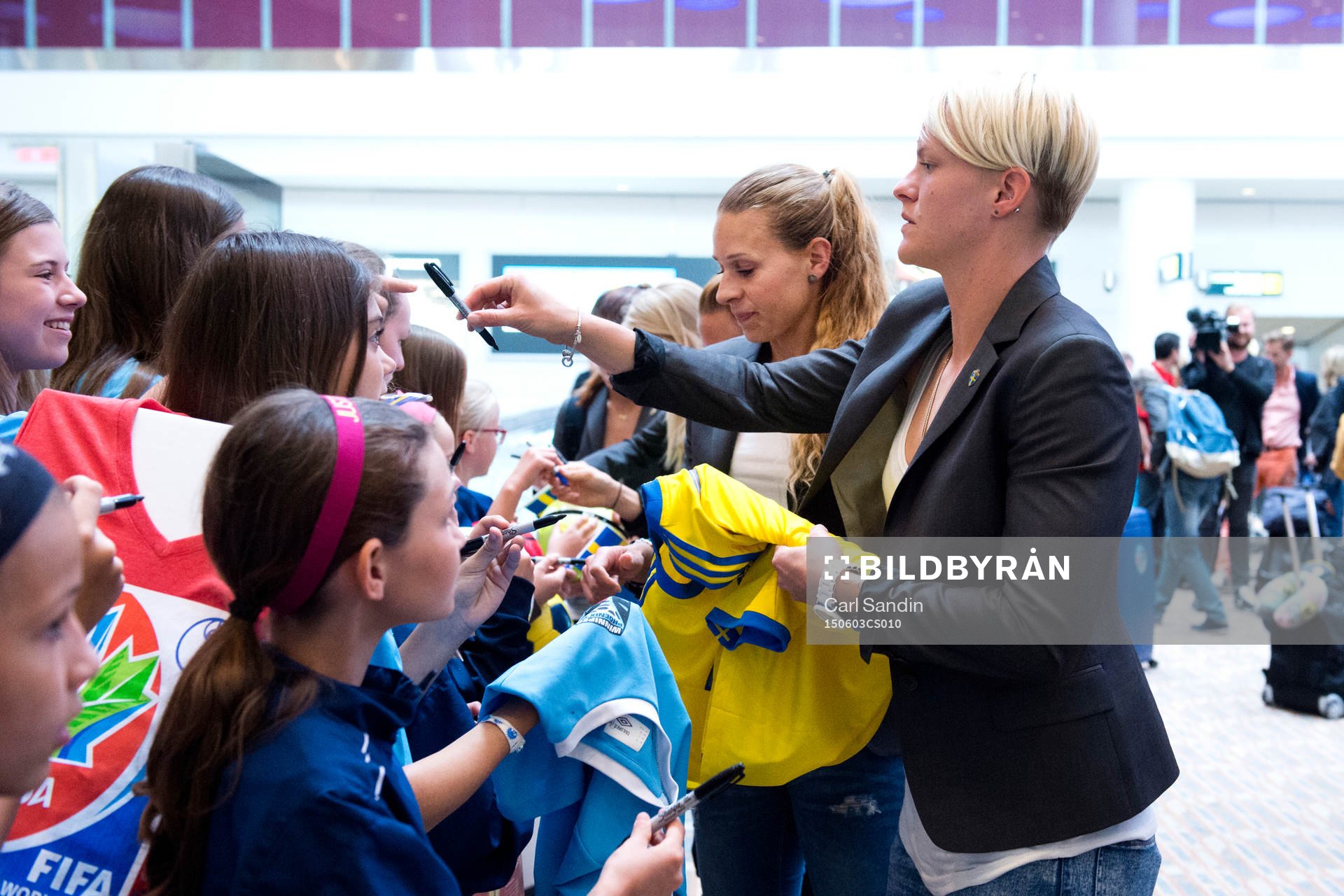 Sveriges Charlotte Rohlin och Nilla Fischer skriver autografer när laget anländer till Winnipeg den 3 maj 2015 i Winnipeg.