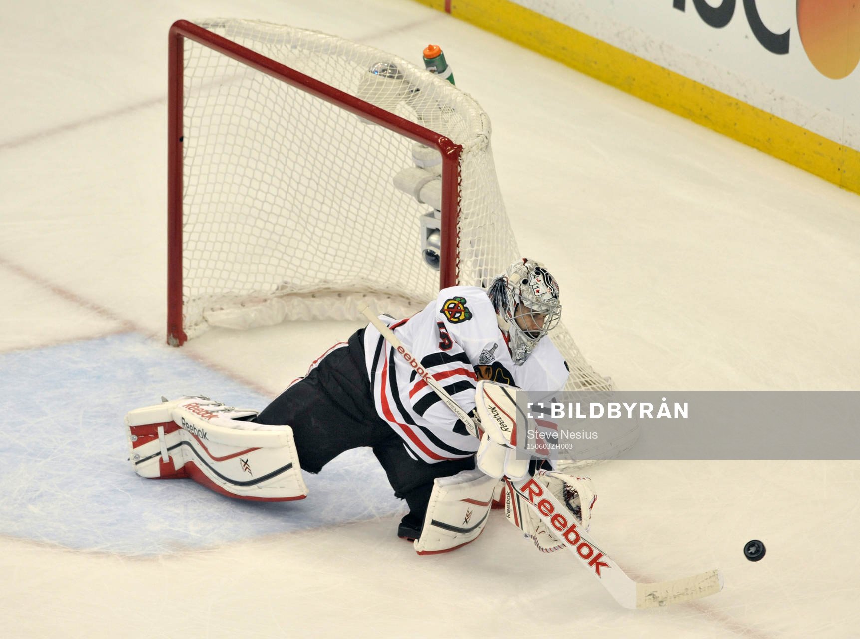 The Blackhawks goalie Corey Crawford (50) clears the puck