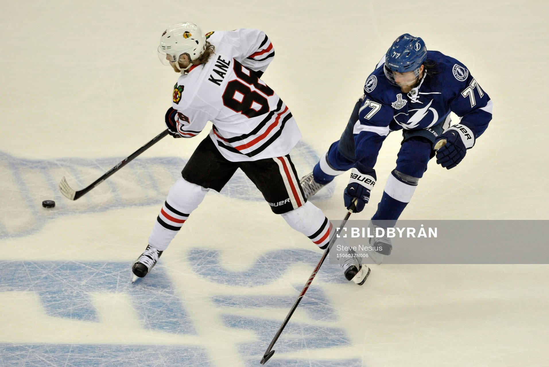 The Blackhawks' Patrick Kane (88) clears the puck from the