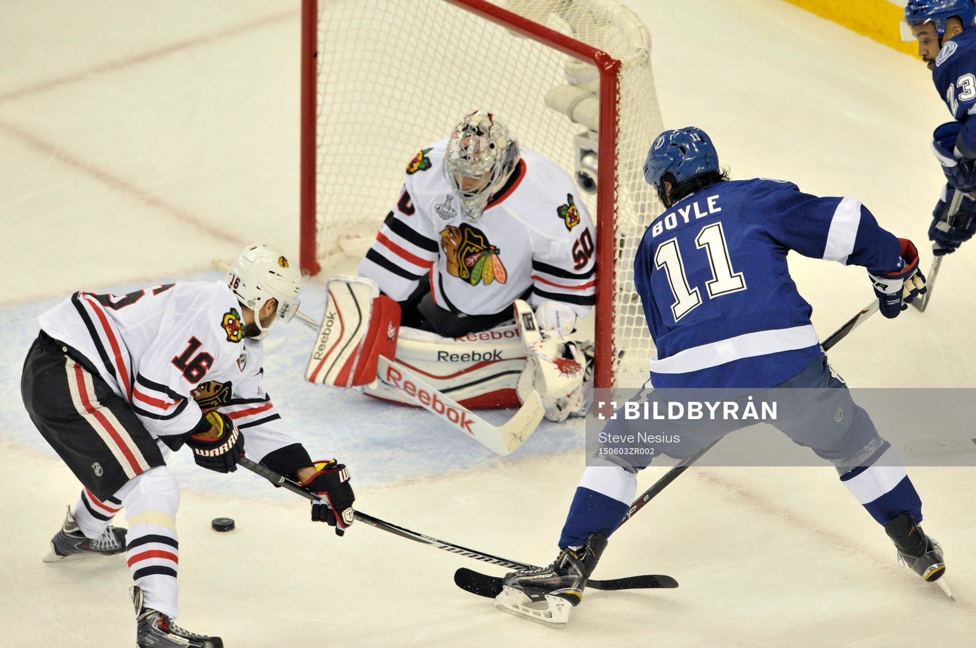 The Blackhawks' Marcus Kriger (16) helps goalie Corey