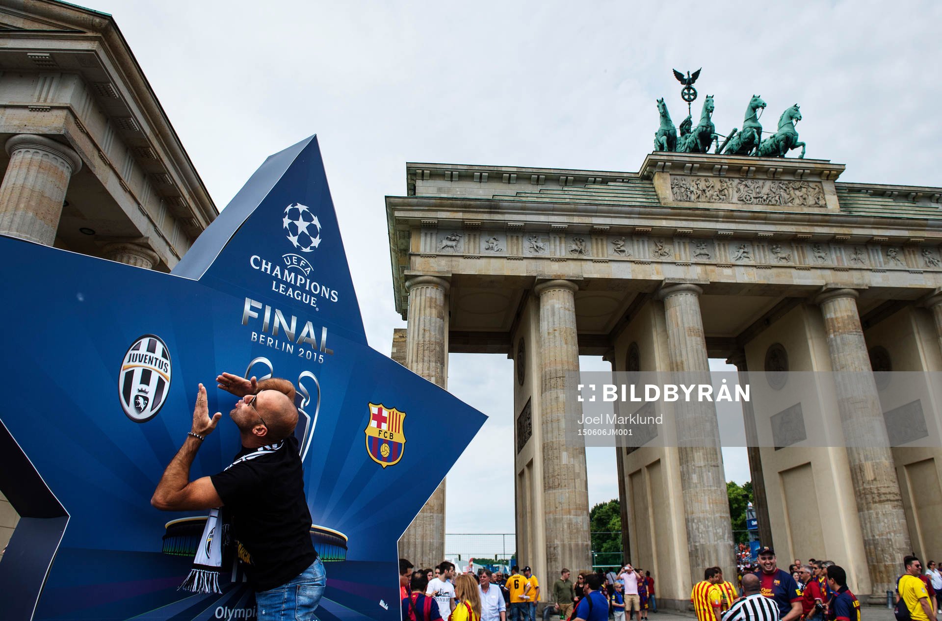 En man kastar slängkyssar mot Juventus emblem i fanzone