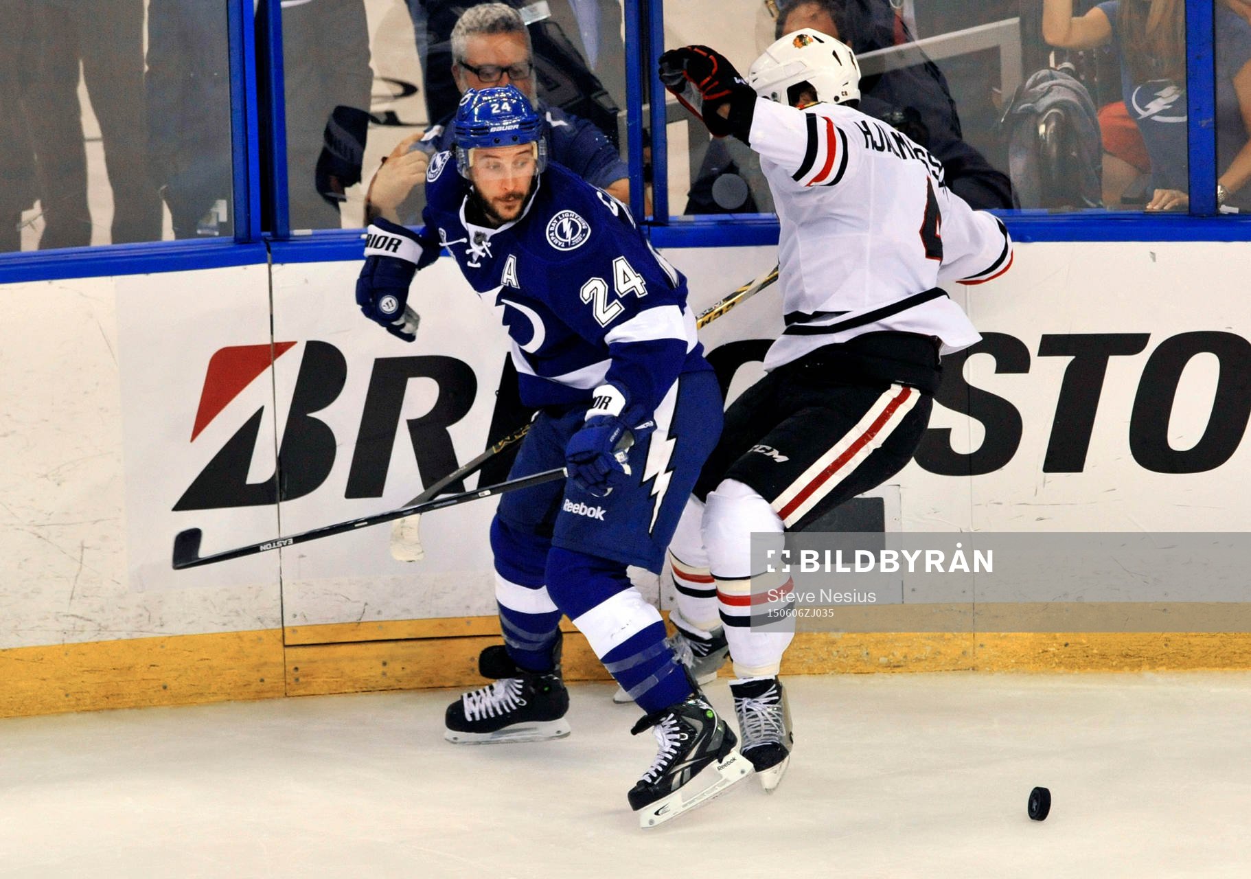The Lightning's Ryan Calahan (24) checks Blackhawks