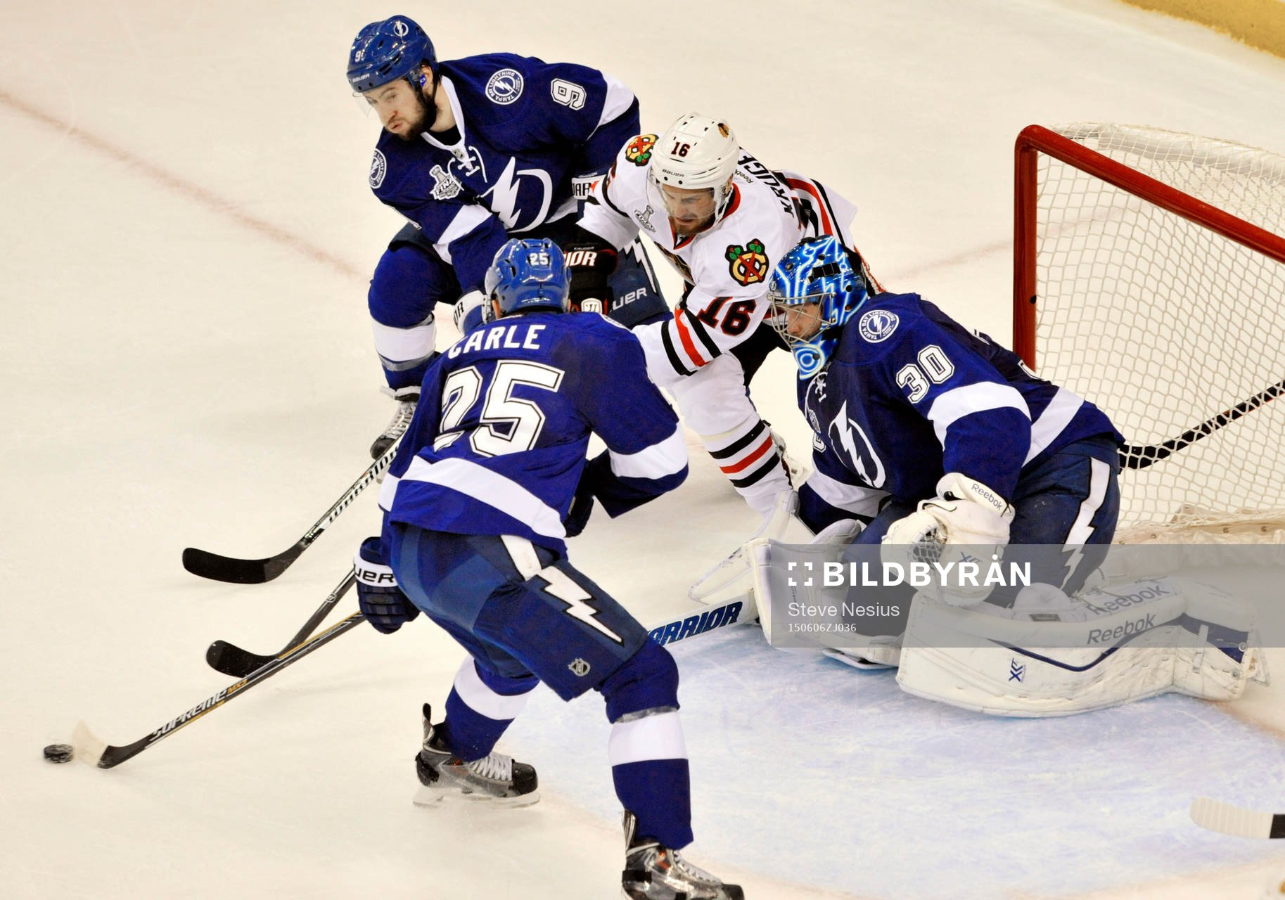 The Lightning's Matthew Carle (25) and Tyler Johnson (9)