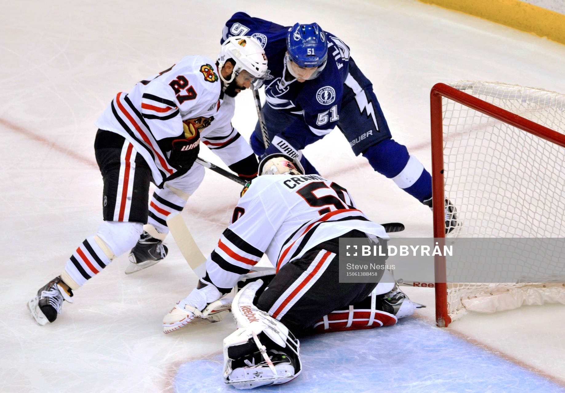 Chicago defenseman Johnny Oduya (27) helps goalie Corey