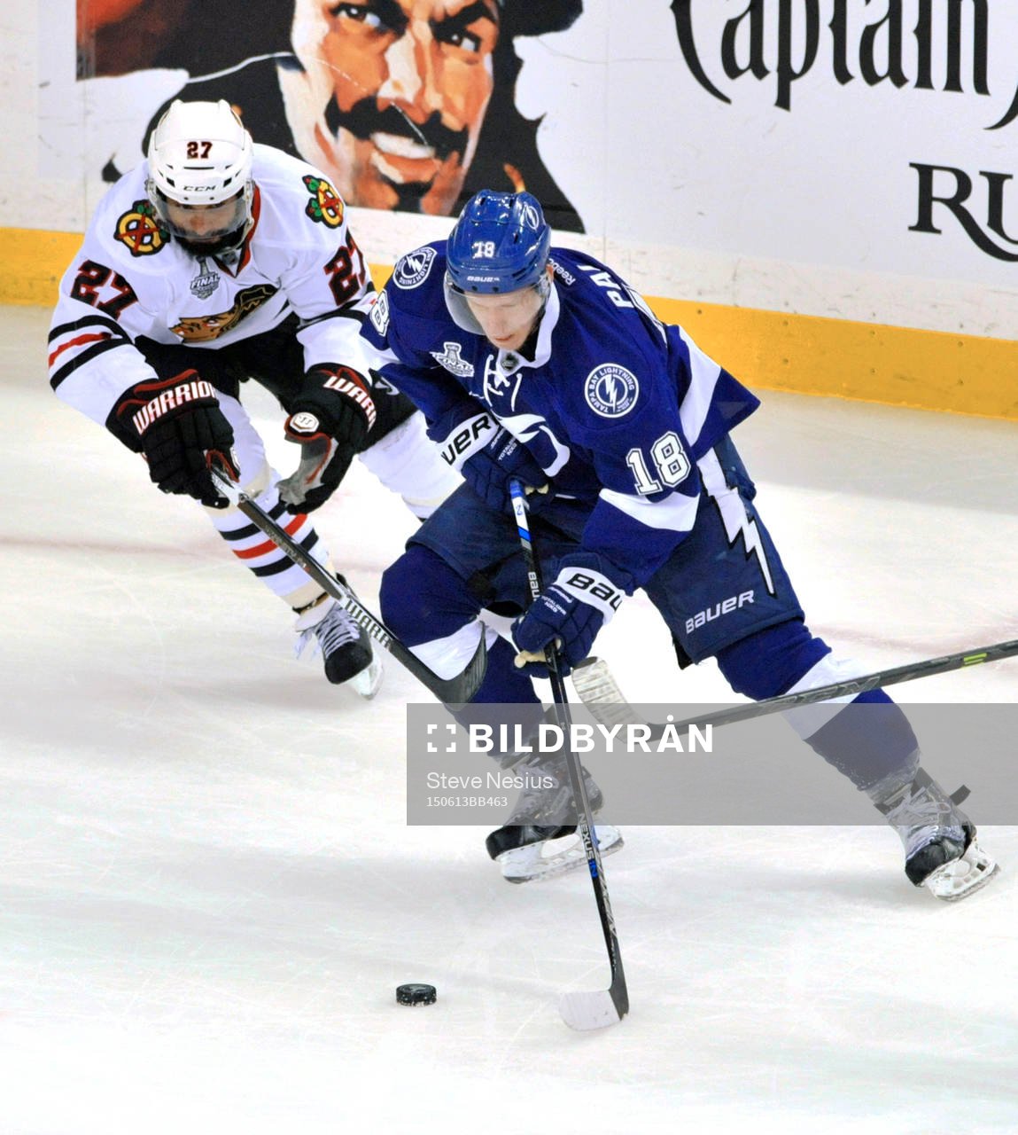 Chicago defenseman Johnny Oduya (27) pressures Tampa Bay's