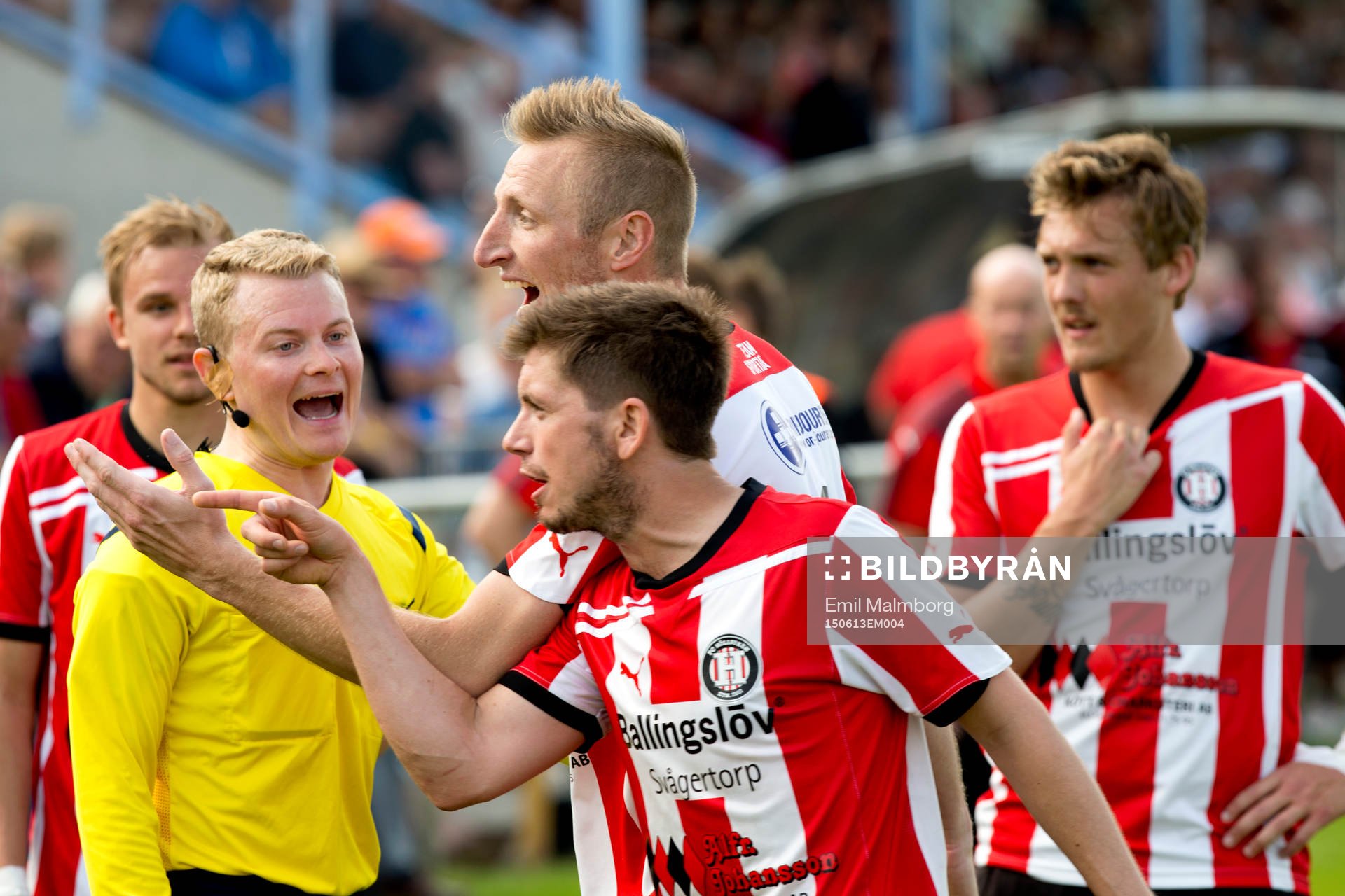 Domaren Fredrik Klitte och spelare från Höllviken under protesterna mot målet under fotbollsmatchen i div 1 mellan Höllviken och Trelleborg den 13 juni 2015 i Höllviken