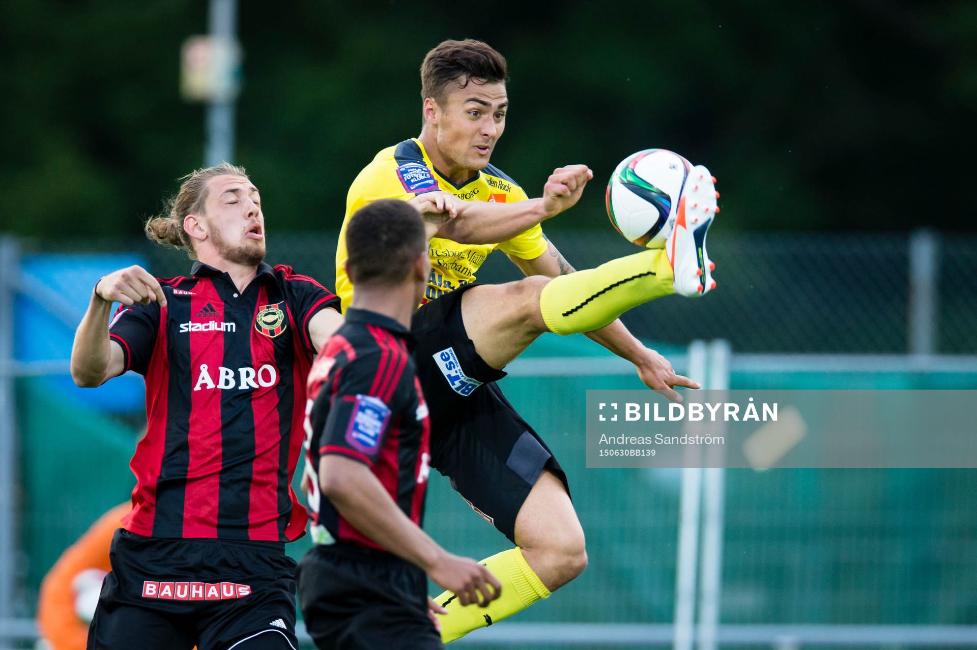 Mjällbys Armin Aganovic sparkar bort bollen framför Brommapojkarnas Isak Nylén (v) och Seth Hellberg under fotbollsmatchen i Superettan mellan Brommapojkarna och Mjällby den 30 Juni 2015 i Stockholm.