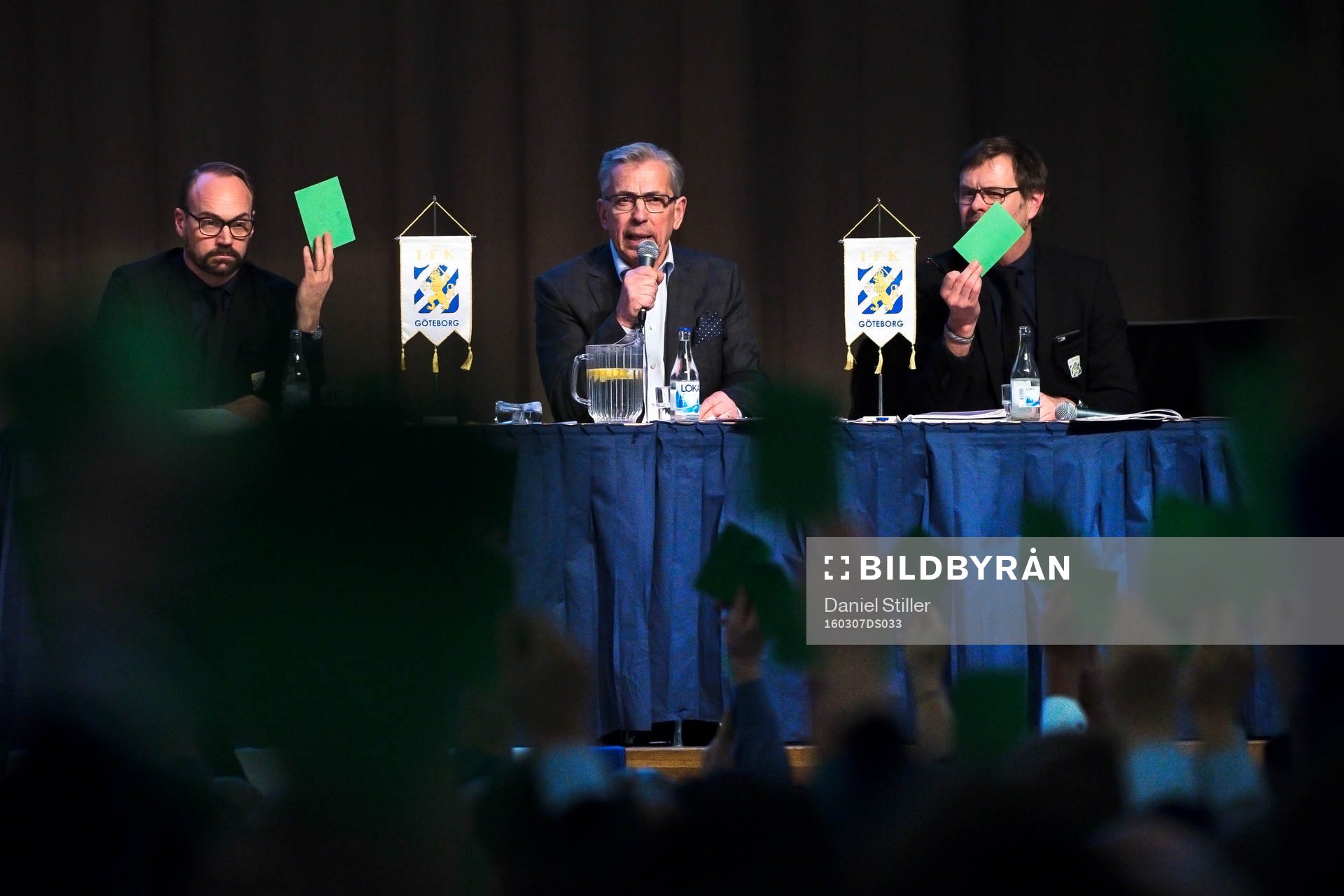Styrelseledamot Olof Myhrman, Jan Hallberg och ordförande Karl Jartun ser på när medlemmar röstar med gröna lappar under IFK Göteborgs årsmöte den 7 mars 2015 i Göteborg.