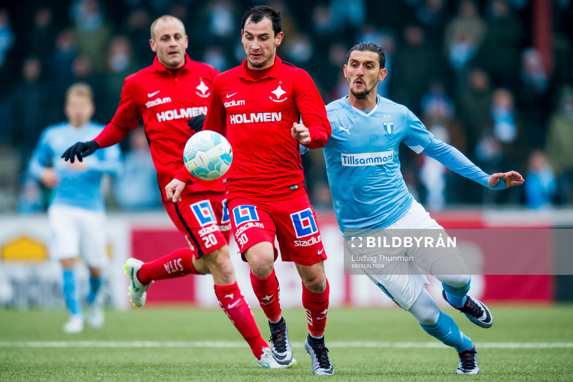 Norrköpings Daniel Sjölund, Nikola Tkalcic i kamp med Malmö FFs Agon Mehmeti under fotbollsmatchen i Svenska Cupen mellan Malmö FF och Norrköping den 13 mars 2016 i Malmö.