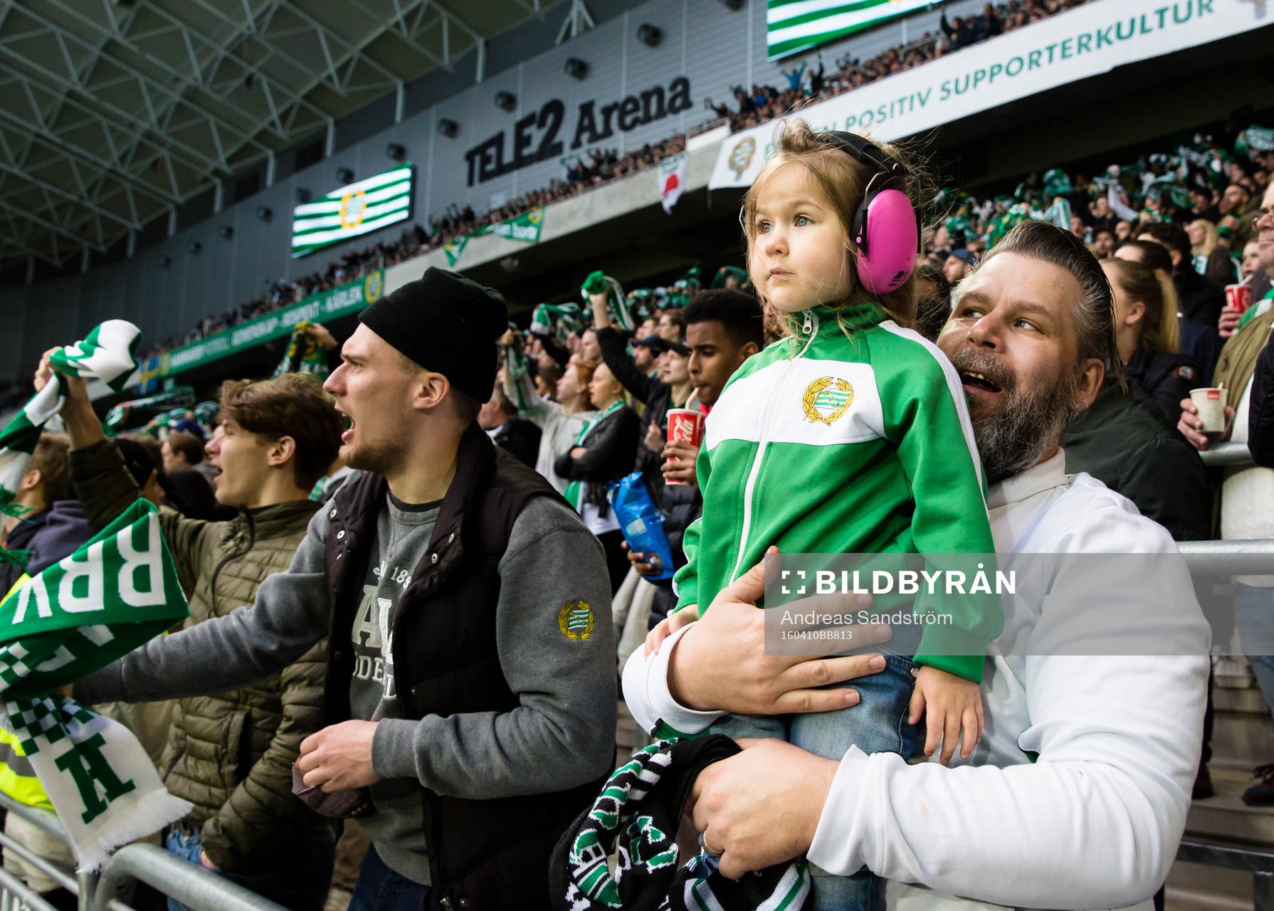 En ung Hammarbysupportar med hörselskydd i klacken