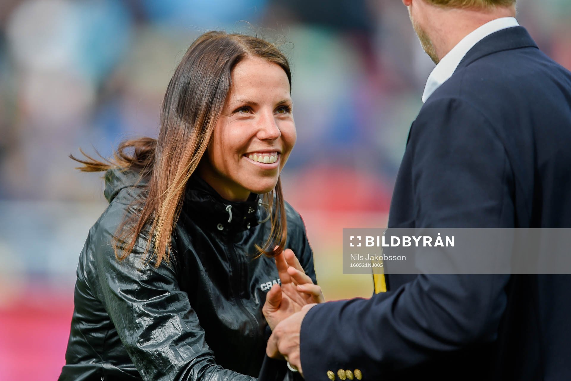 Charlotte Kalla delar ut matchtröja före fotbollsmatchen