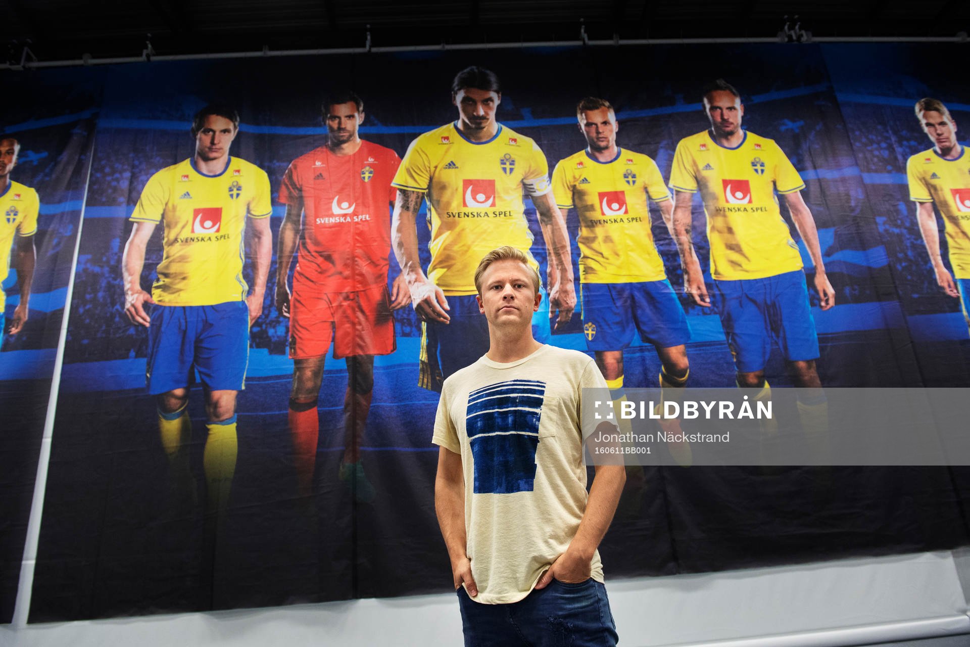 Bildbyråns fotograf Joel Marklund poserar i mediacentret framför en vägg med bilder av spelare i fotbollslandslaget fotograferade av honom, i samband med Sveriges fotbollslandslags träning under fotbolls-EM den 11 juni 2016 i Saint-Nazaire.