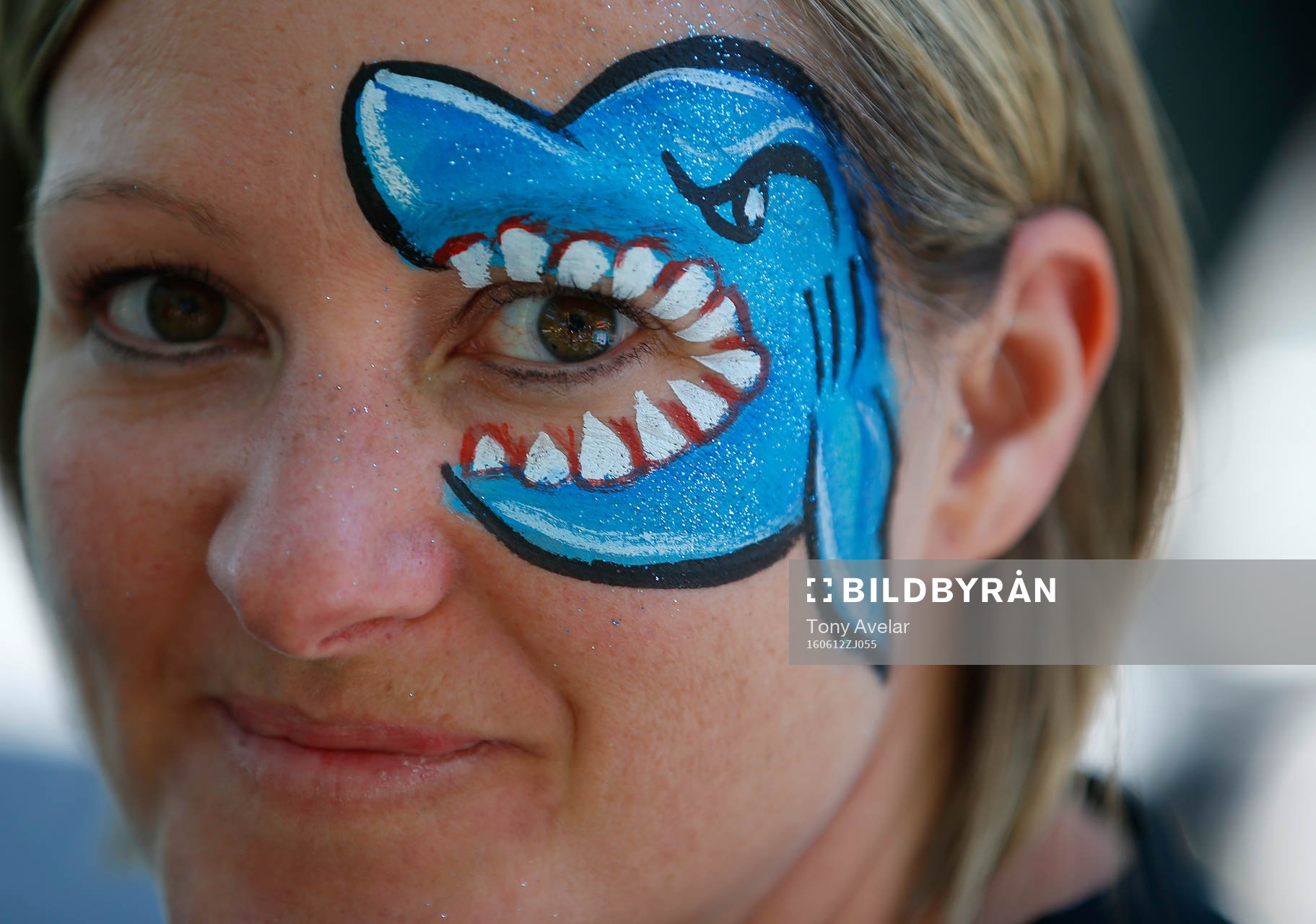 A Sharks fan decorates her face