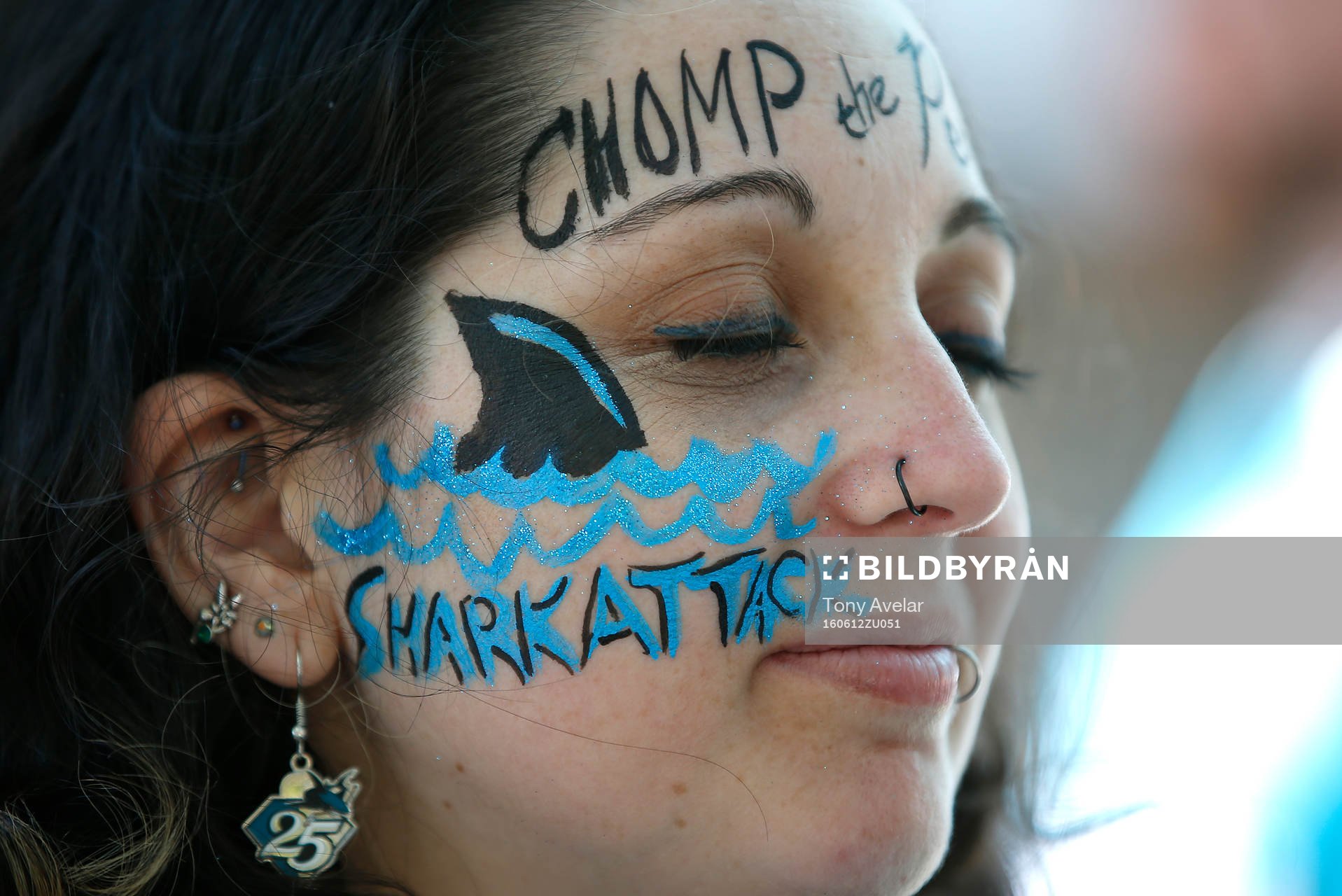 A Sharks fan decorates her face