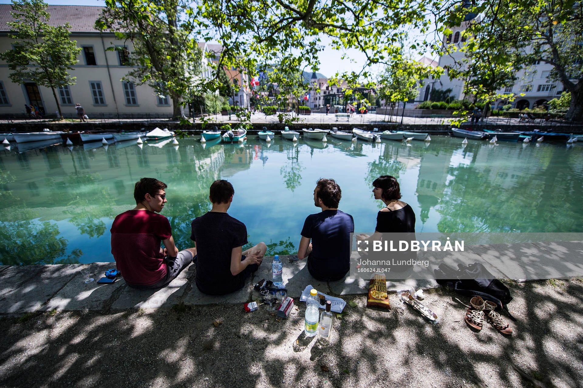 Ungdomar från Annecy  har picknick vid ån där Island har sitt basläger under fotbolls-EM den 24 juni 2016 i Annecy.