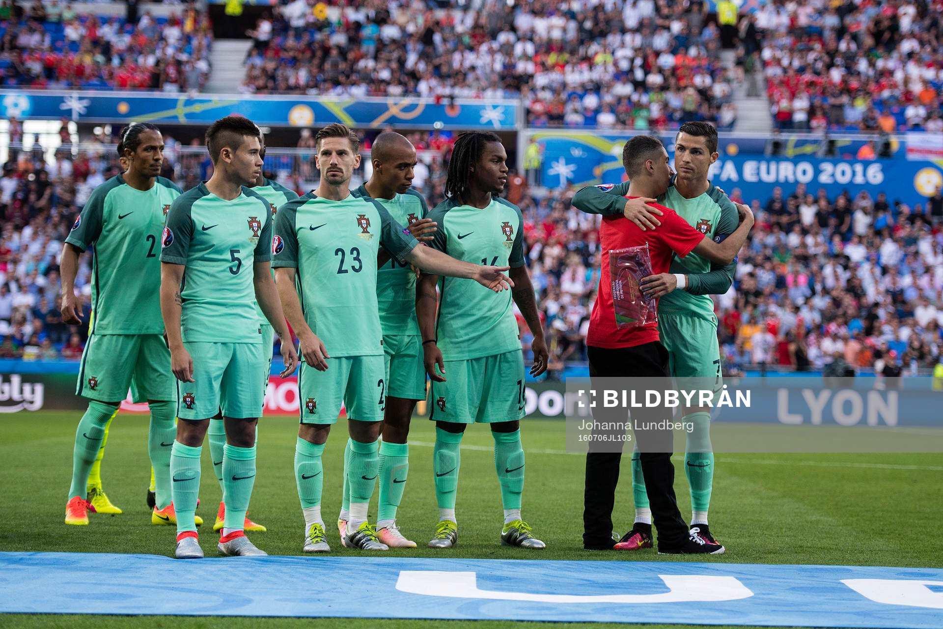En person tar sig in och kramar Portugals Cristiano Ronaldo