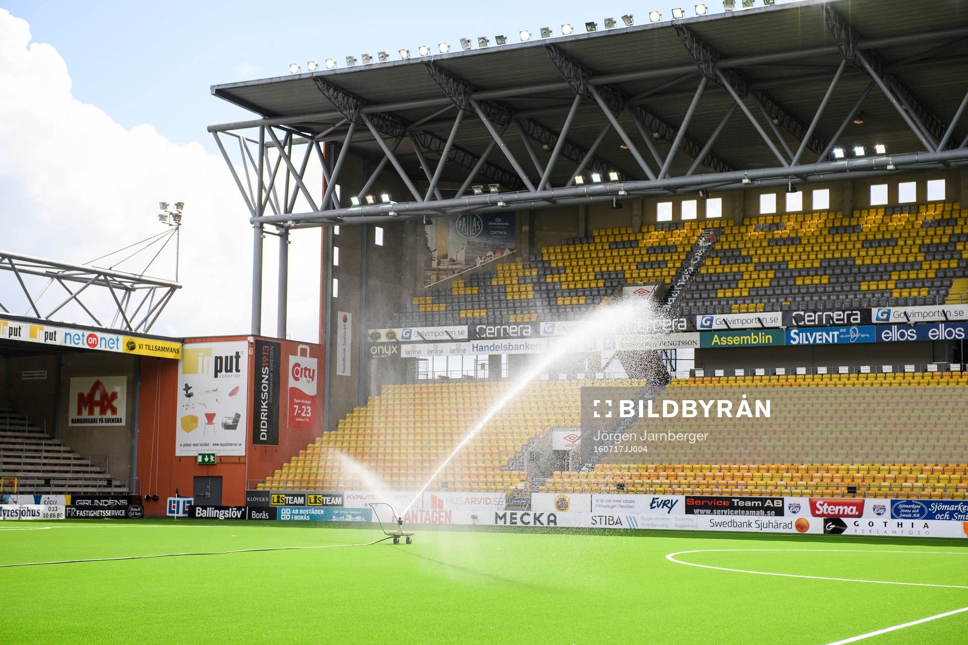 Vattning av konstgräset innan fotbollsmatchen i