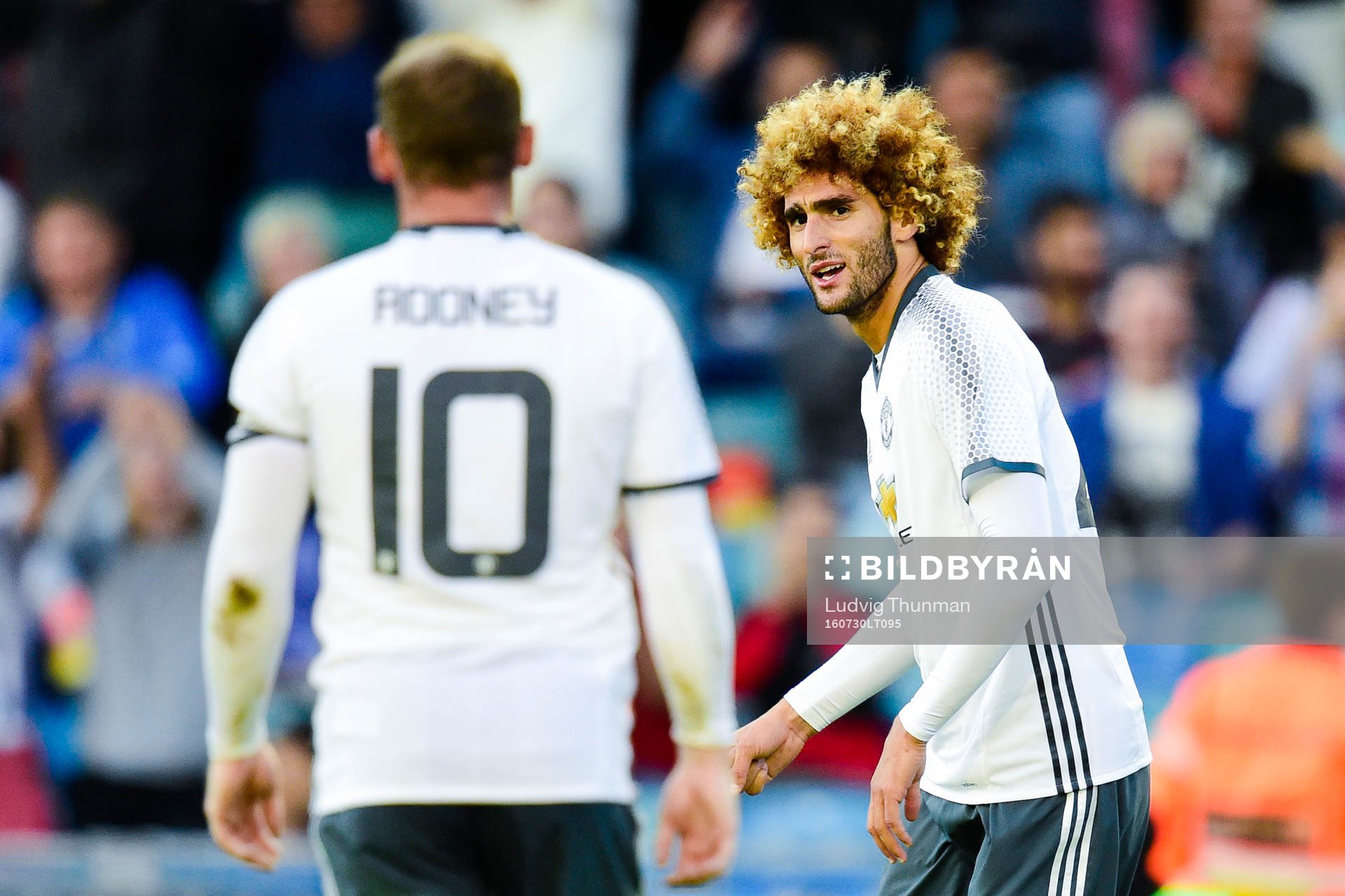 Manchester Uniteds Wayne Rooney och Marouane Fellaini jublar