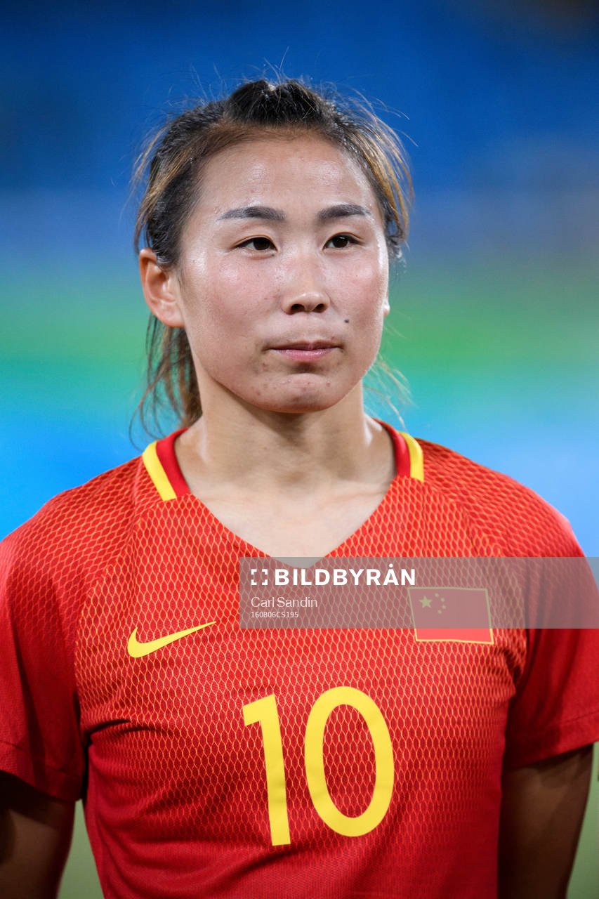 Kinas Li Yang vid lineup innan fotbollsmatchen mellan