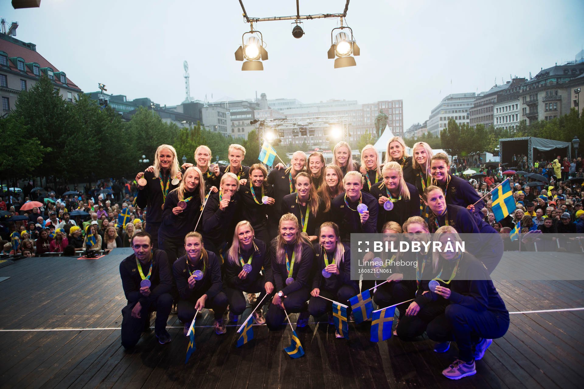Sarah Sjöström (t v övre raden) och Marcus Svensson (t v nedre raden) poserar för en gruppbild tillsammans med damlandslaget i fotboll när de svenska OS-medaljörerna firas i Kungsträdgården den 21 augusti 2016 i Stockholm.