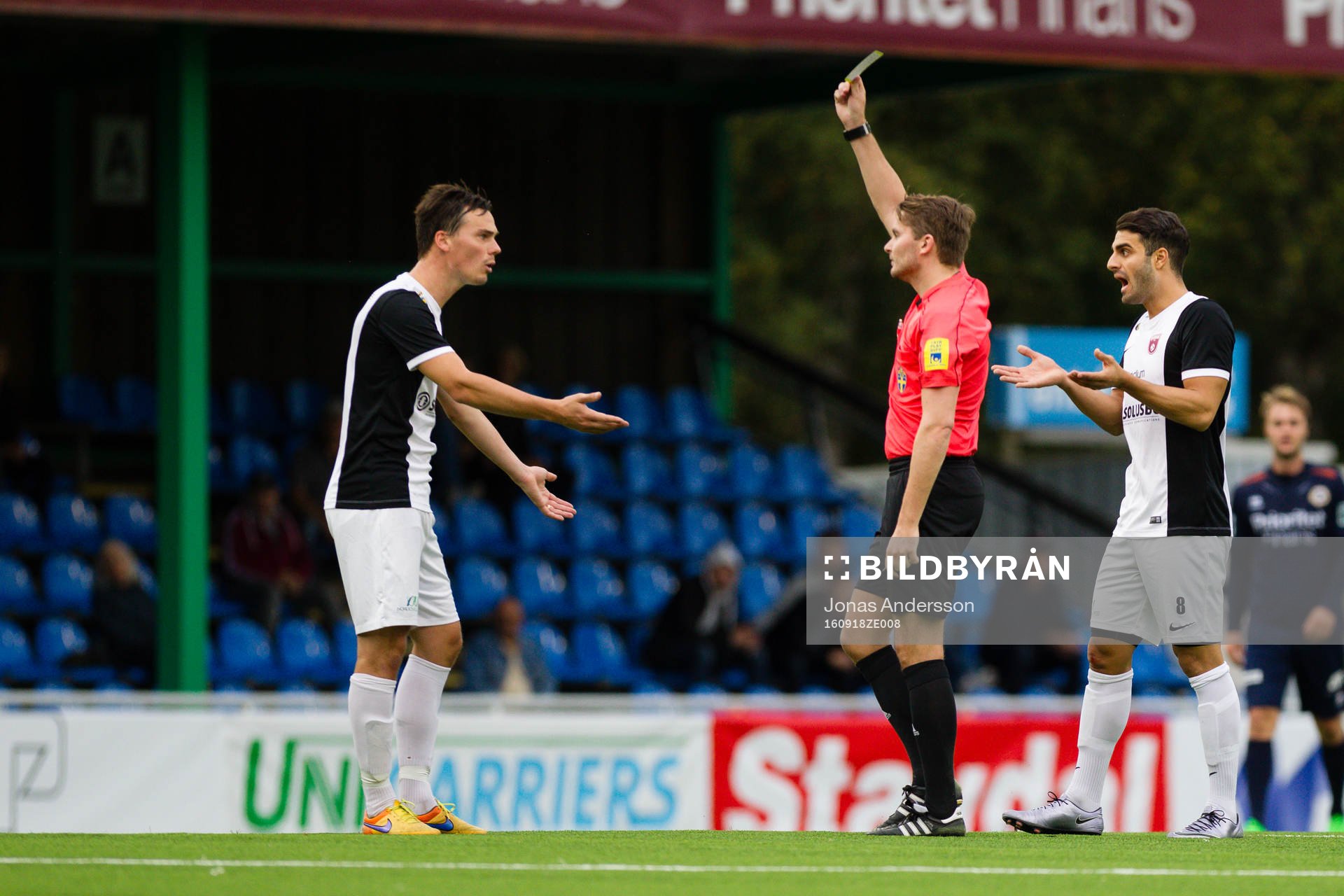 Qvidings Rickard Hansson (v) varnas av Joakim Östling (m) och Arvin Shojaee (h) reagerar på kortet under fotbollsmatchen i Division 1 södra mellan Utsikten och Qviding den 18 september 2016 i Göteborg.
