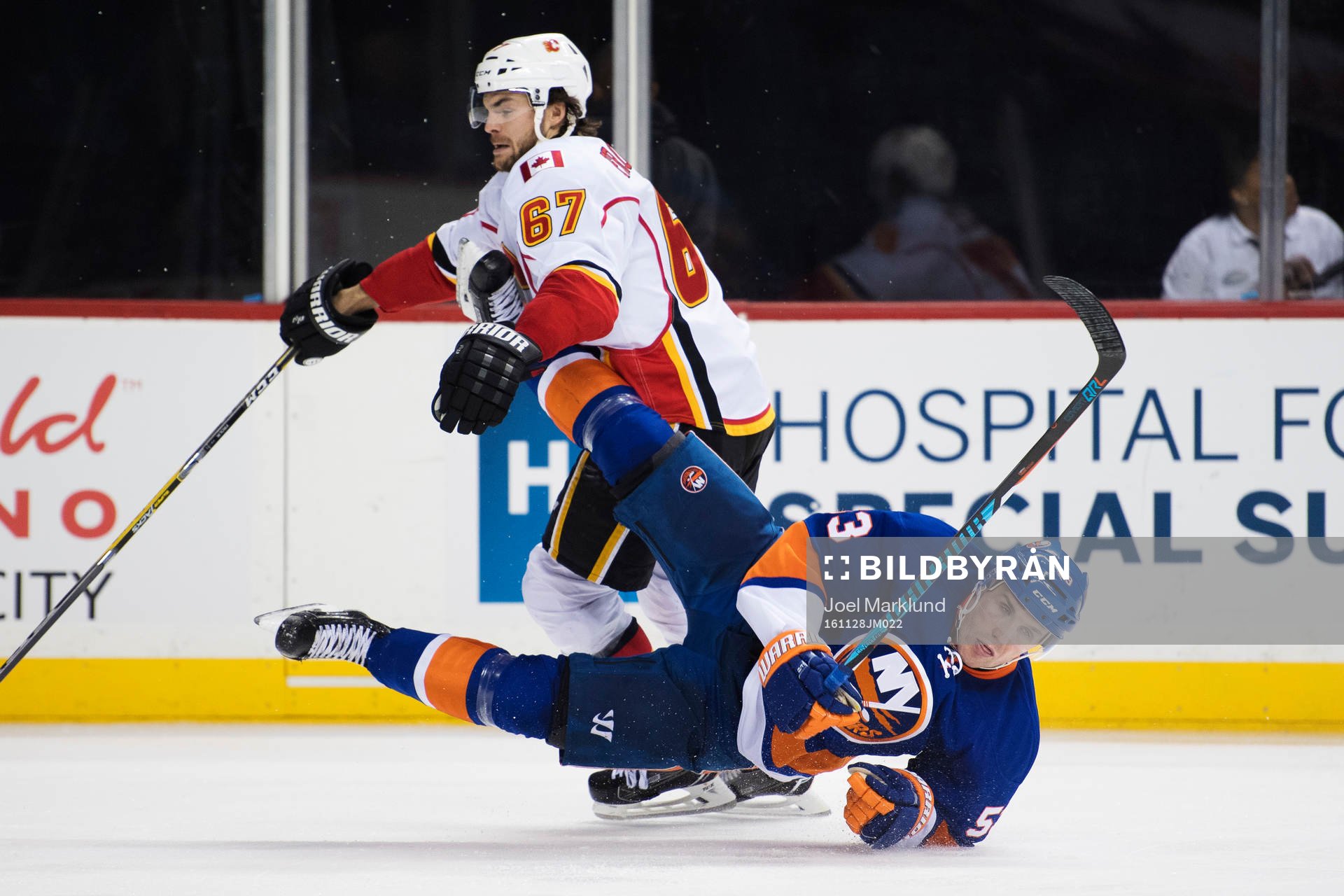 Calgarys Michael Frolik tacklar New Yorks Casey Cizikas