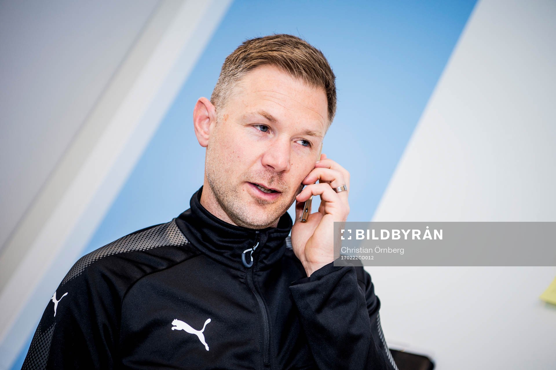 Huvudtränaren i Malmö FF, Magnus Pehrsson, med telefon i