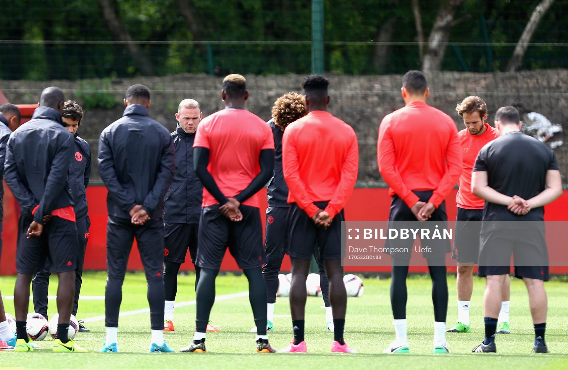 The Manchester United players and staff hold a minute