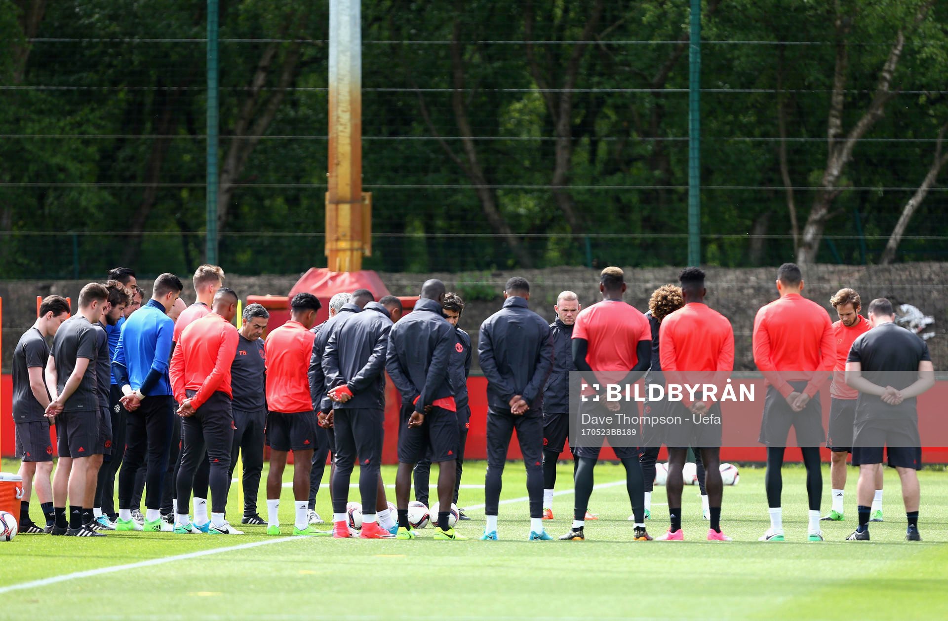 The Manchester United players and staff hold a minute