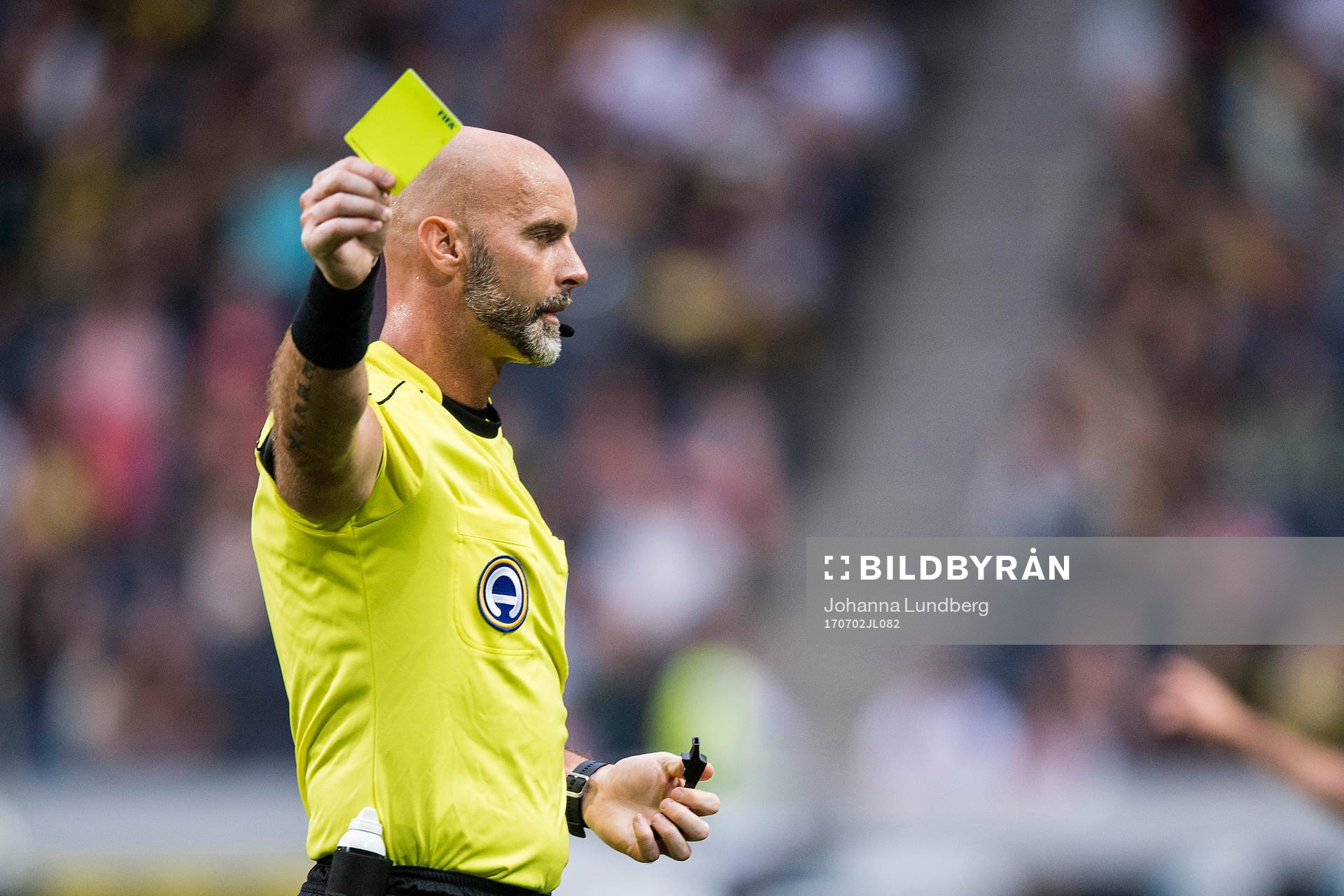 Domare Stefan Johannesson delar ut ett gult kort