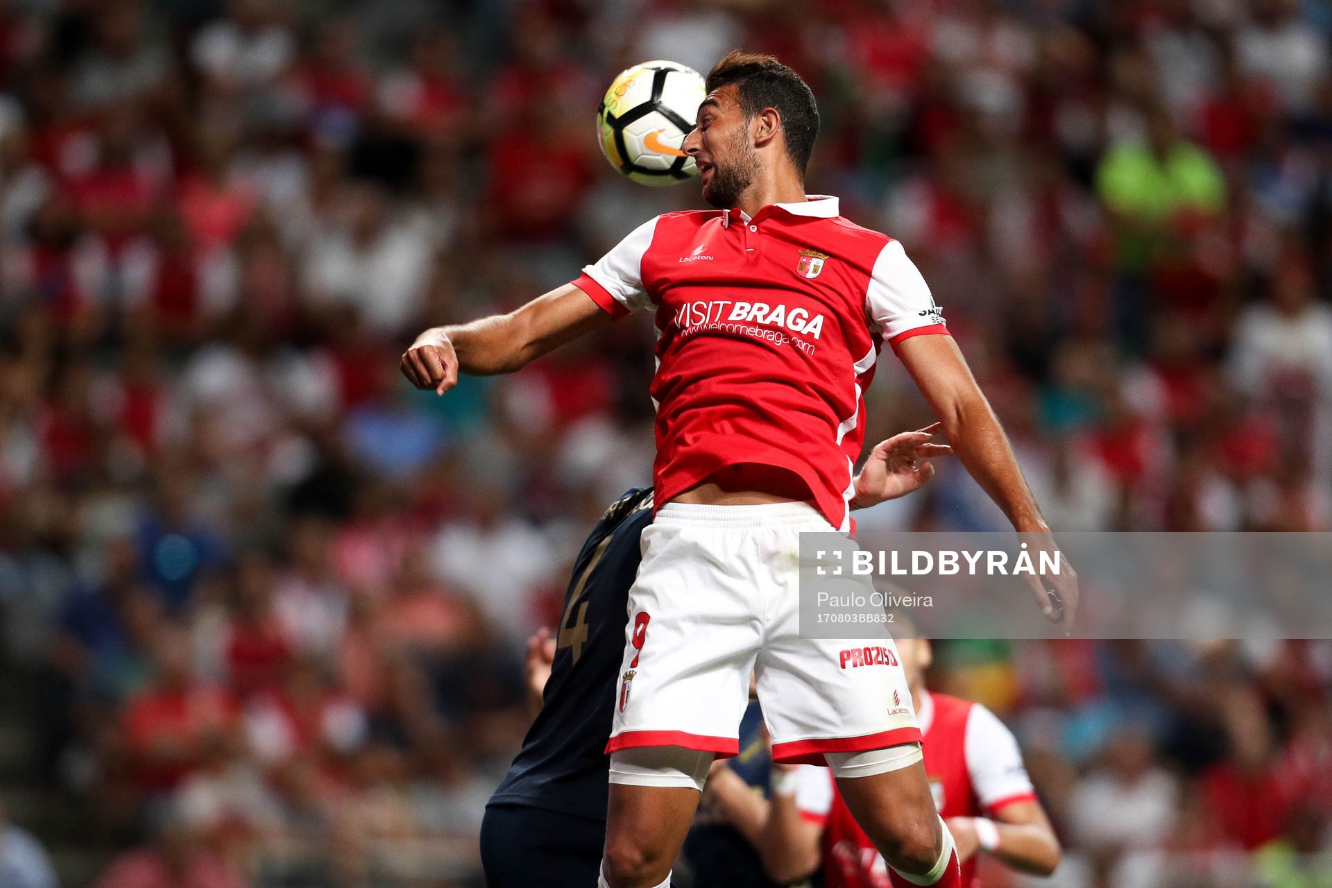Ahmed Hassan forward of SC Braga (R) vies with Nils-Eric