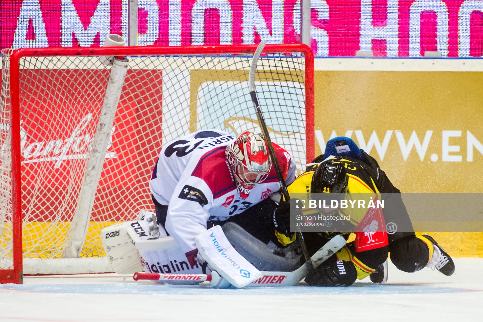 Kevin Clark of Brynäs collides with Goalkeeper Atte Engren
