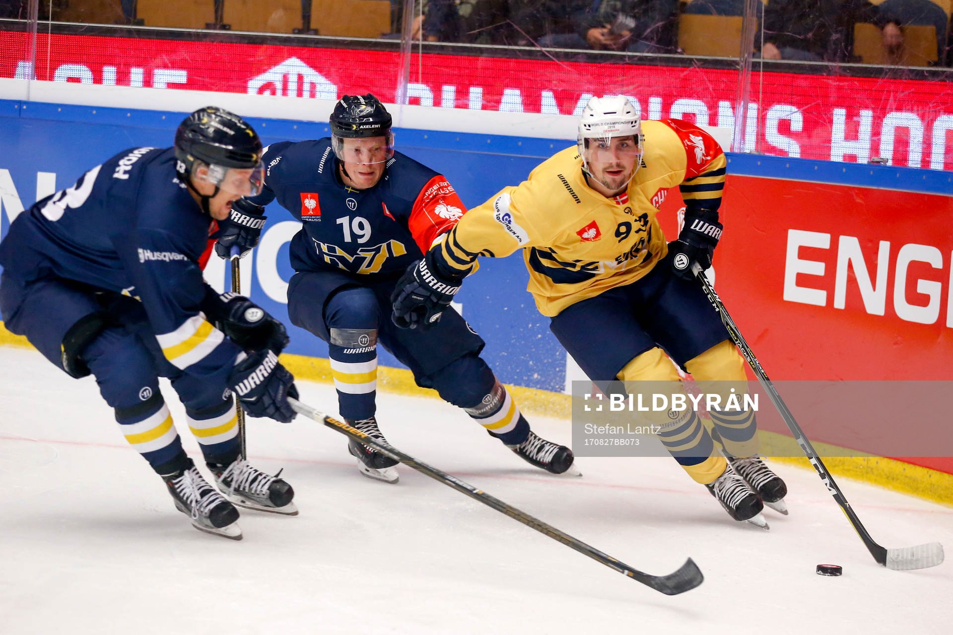 Oscar Sundh and Erik Andersson of HV71 and Taylor Fleming