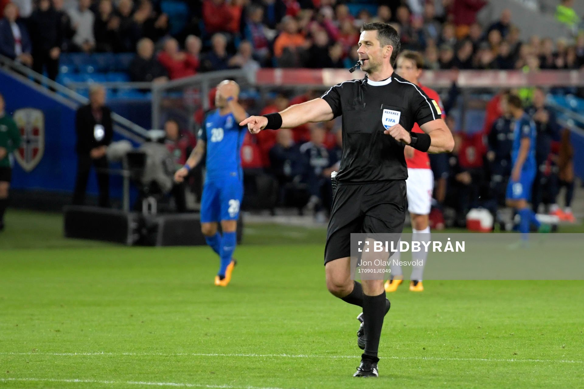 The referee Daniel Stefanski signals for a penalty for