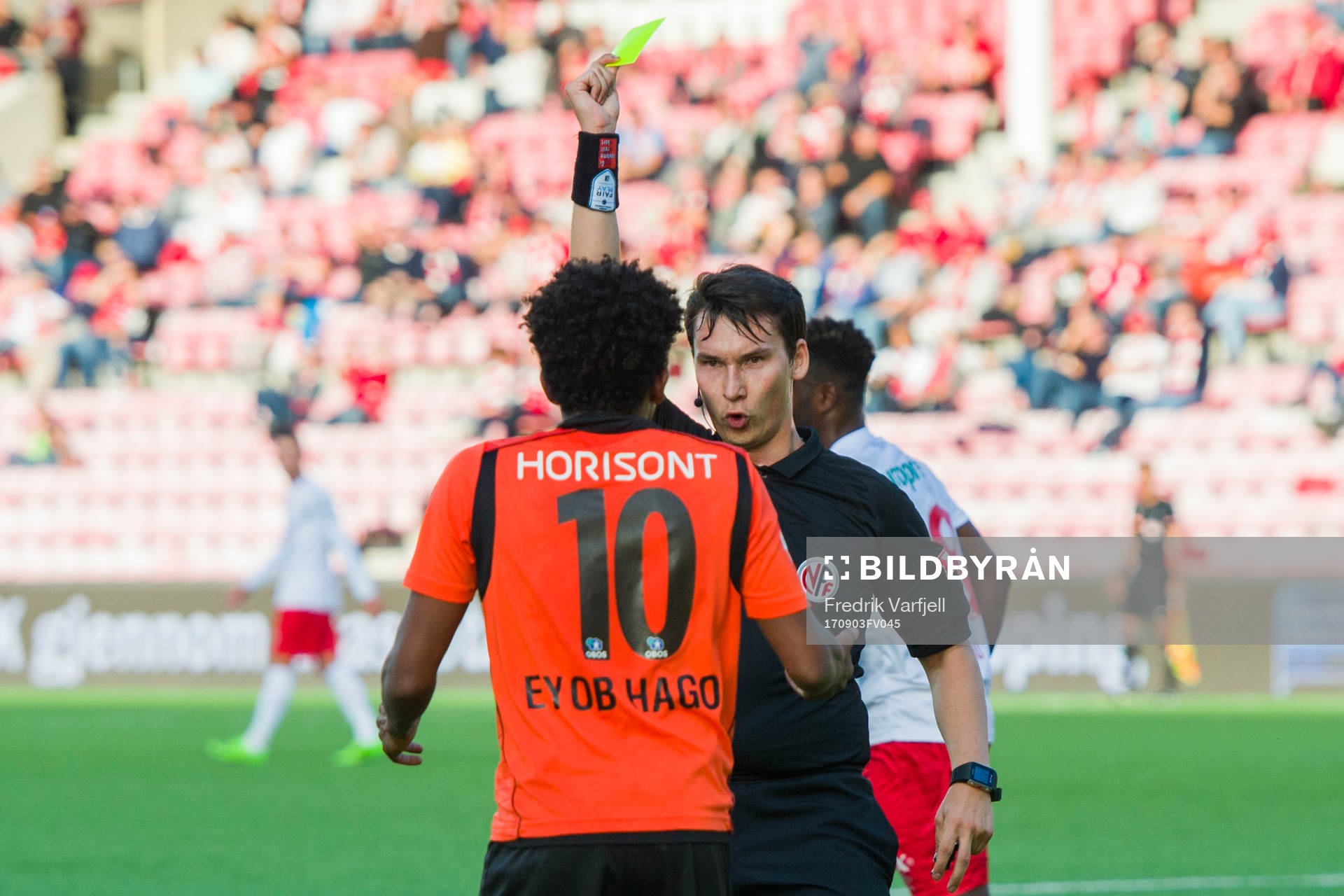 Senai Eyob Hagos of Åsane is shown a yellow card from by