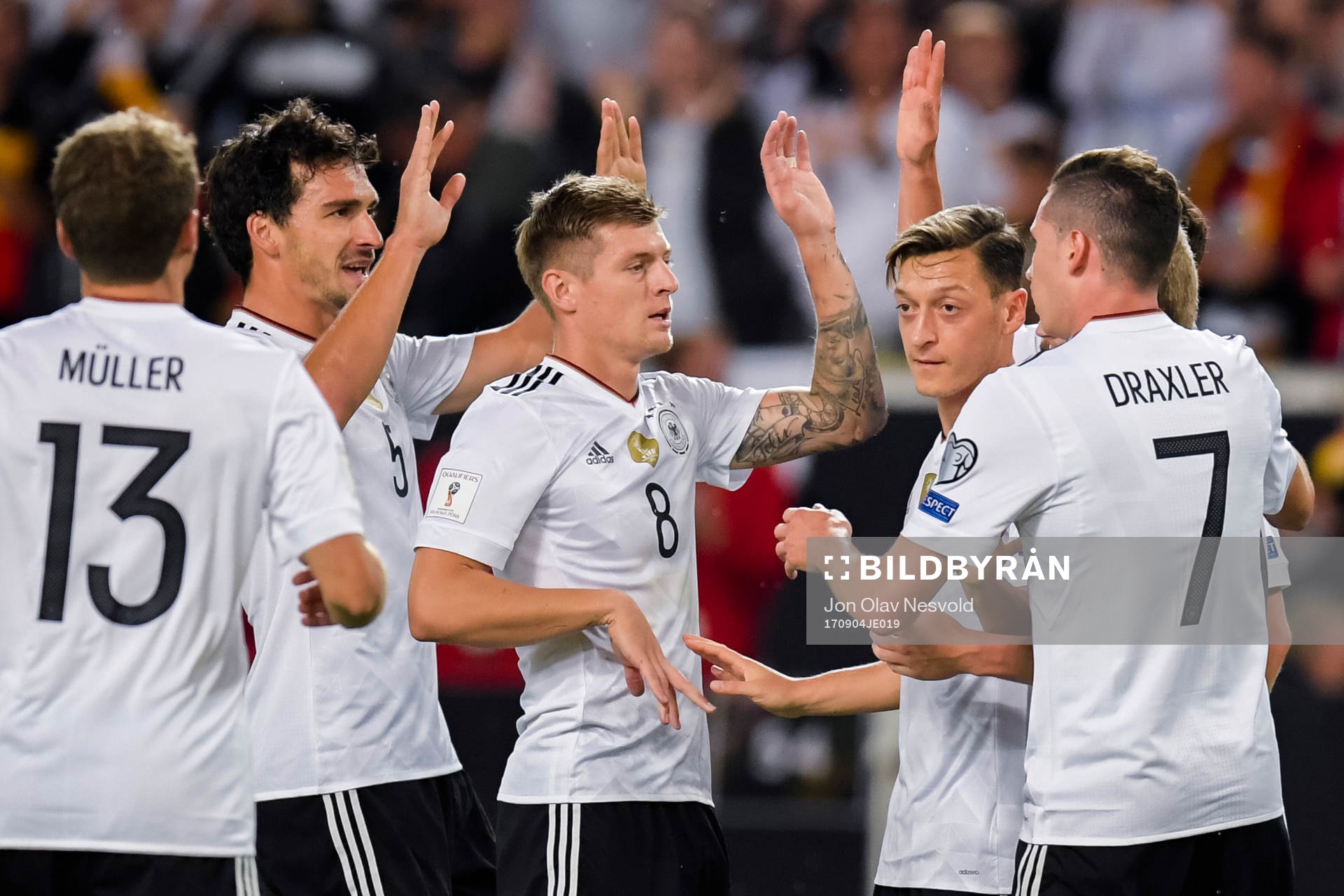 Mesut Özil of Germany celebrates with teammates after scoring the 1-0 goal during the FIFA World Cup Qualifier match between Germany and Norway on September 4, 2017 in Stuttgart.
