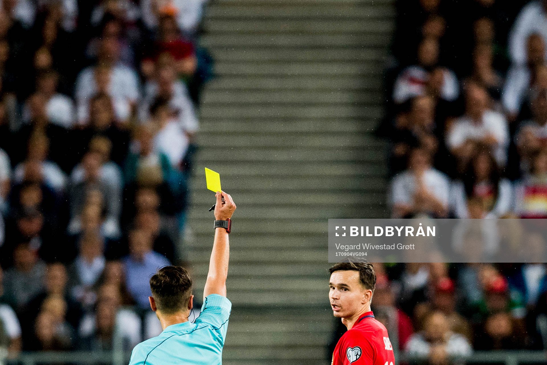 Ole Kristian Selnæs of Norway receives a yellow card