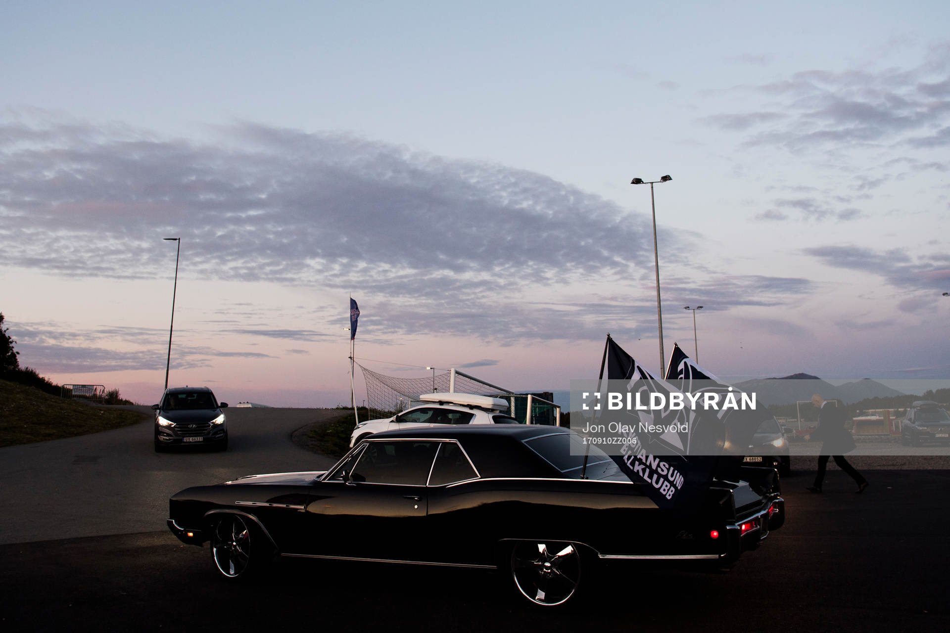 A car with flags of Kristiansund Ballklubb outside the arena