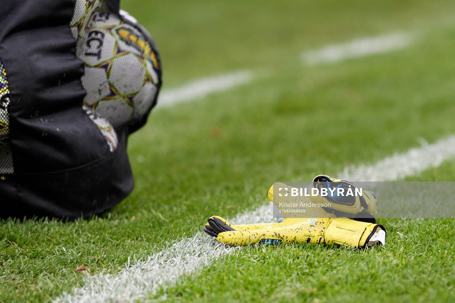 Målvaktshandskar och bollar före fotbollsmatchen i