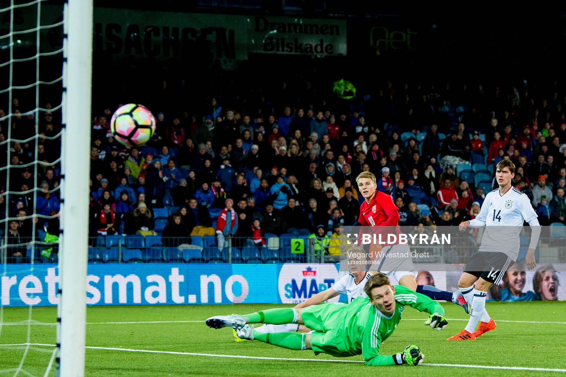 Martin Ødegaard of Norway scores 2-1 behind goalkeeper