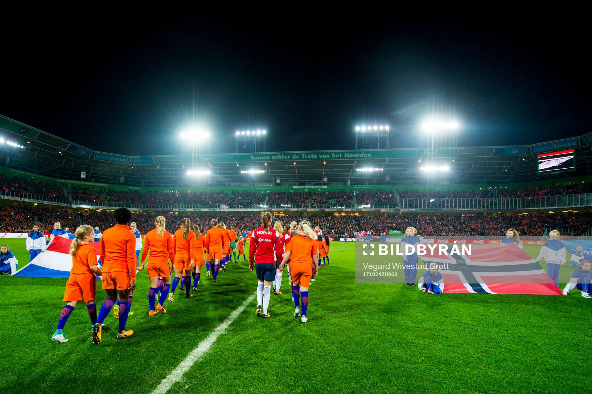 The teams enter the pitch