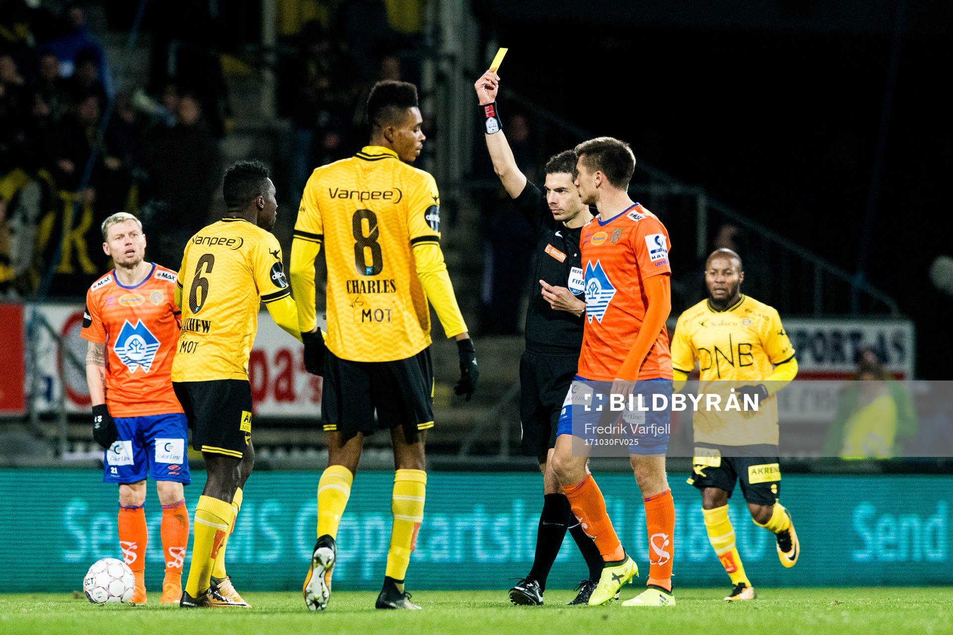 Tore Hansen, referee, gives a yellow card to Ifeanyi